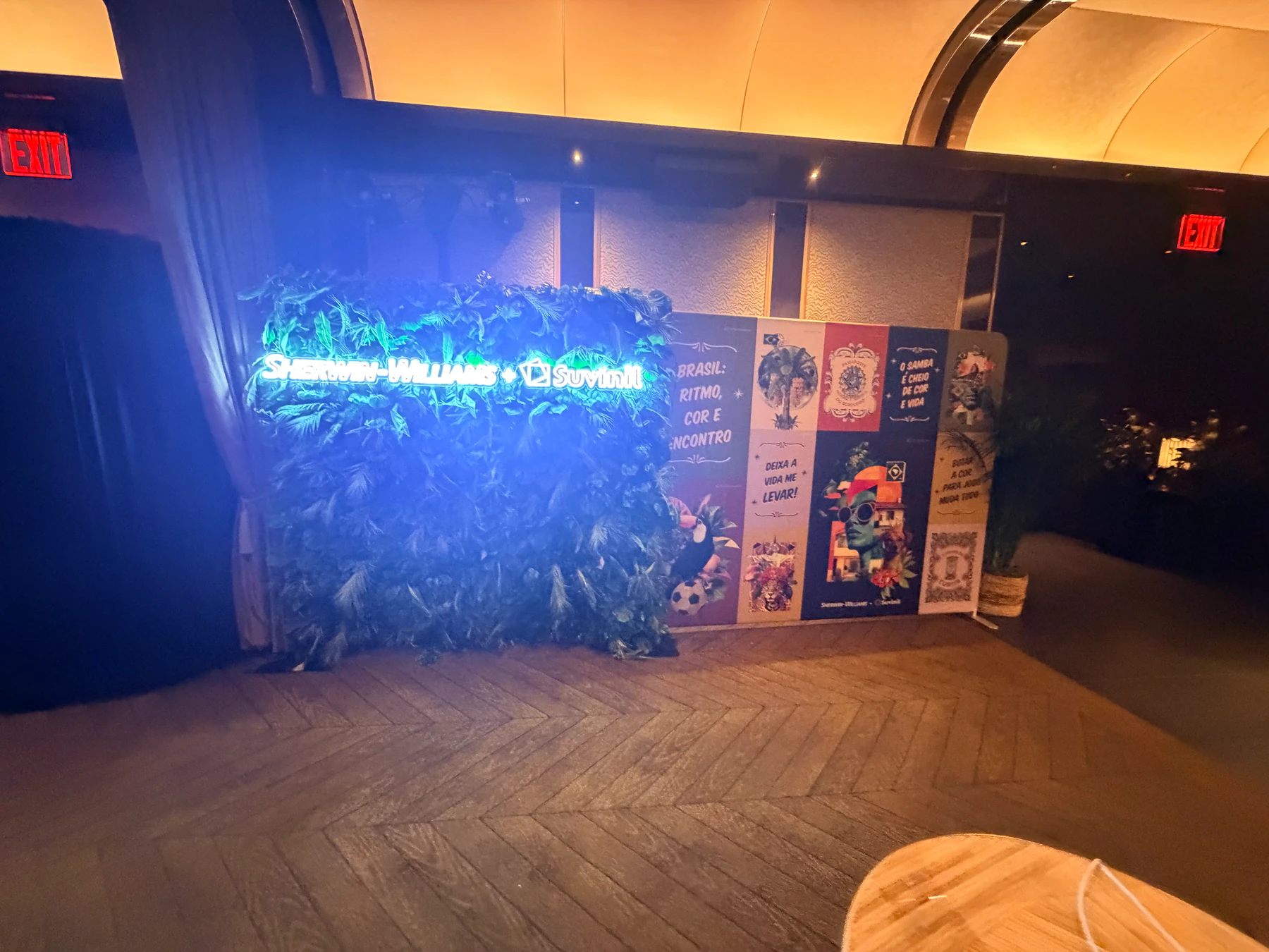 Photo booth beside a branded greenery wall at a Sherwin-Williams corporate event