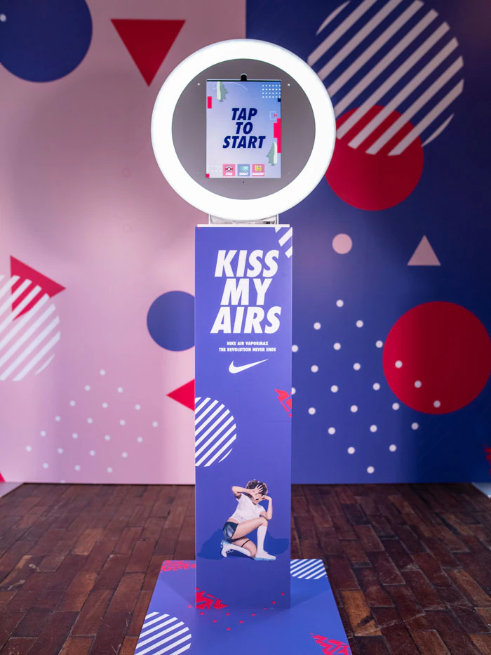 Branded event installation with custom signage and floral backdrop at a New York corporate event