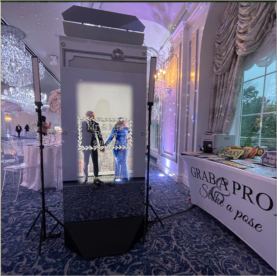 Guests posing at a photo booth beside a floral backdrop at a New York City event